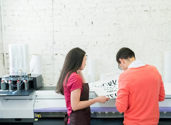 printing-specialists-examining-banner-in-office.jpg